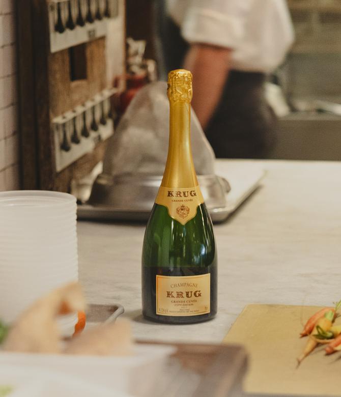A bottle of Krug Grande Cuvee in a kitchen